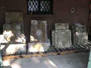 The ground floor paving stones are temporarily stored under the portico.