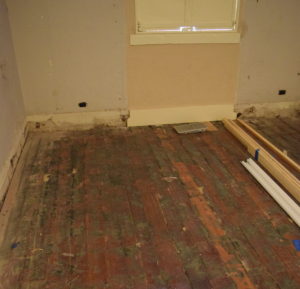 The removal of carpet from the microfilm room revealed wood floors.